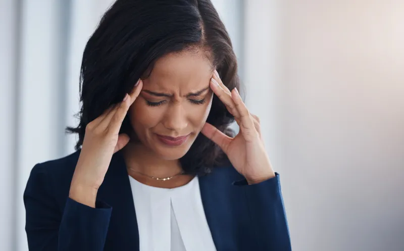 Woman suffering from chronic migraine headache