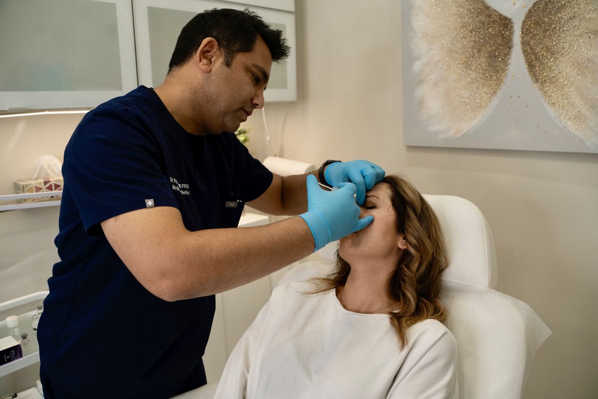 Dr. Rohit Kumar performing cosmetic consultation at RK Medical Aesthetics